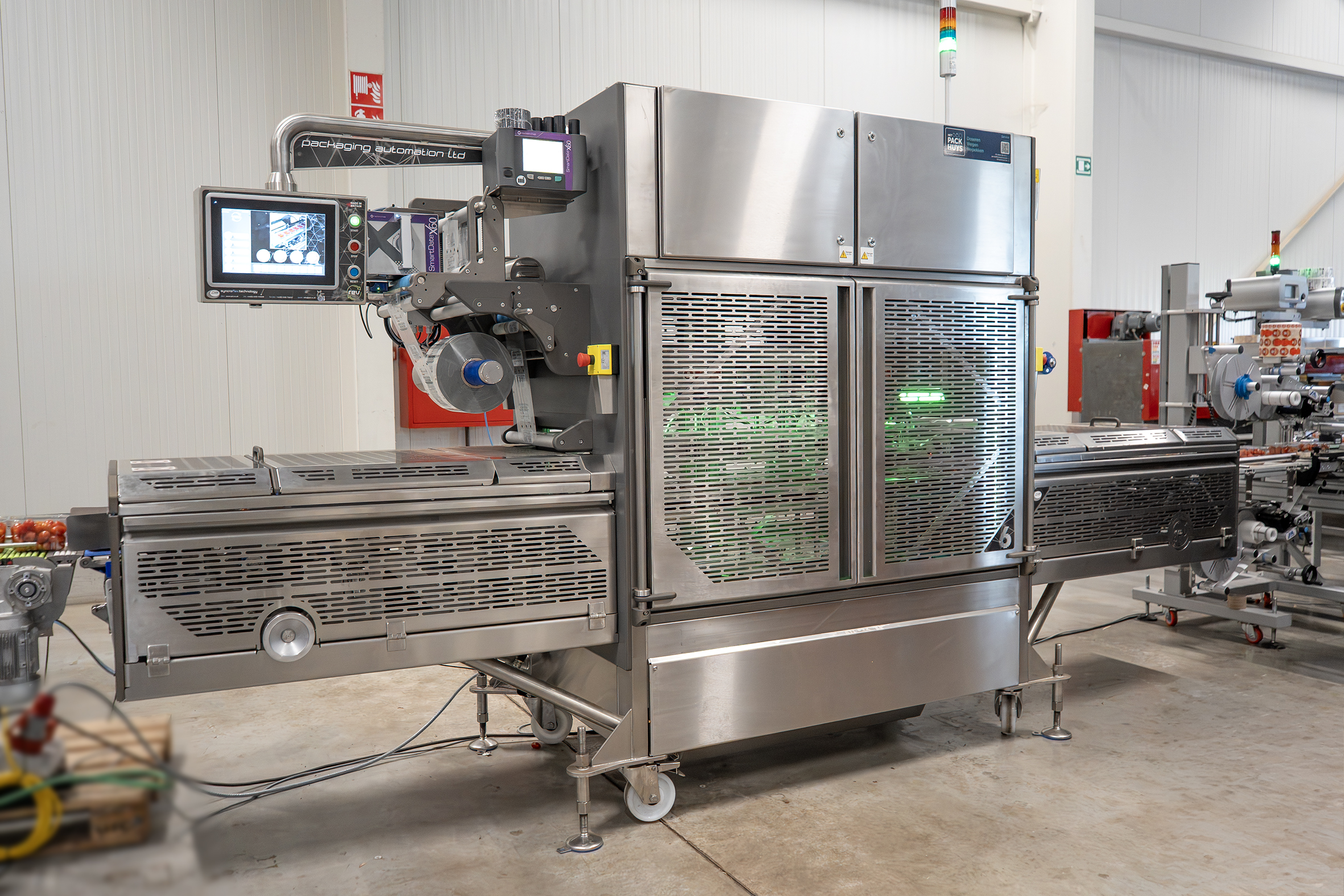 The Packaging Automation REV6 top sealer installed on the packing line at Den Berk Délice